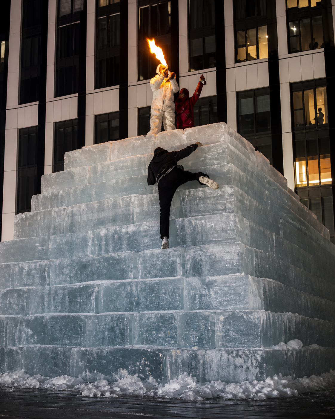 Ice climbers atop a frozen pyramid in the city